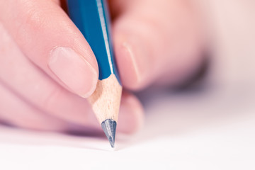 Female hand writing, macro shot