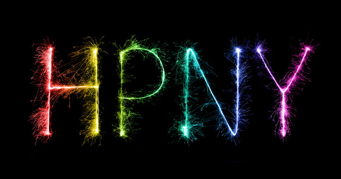Happy New Year made of sparkles firework at night