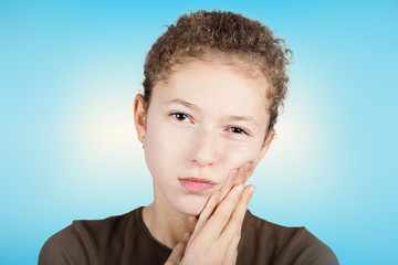 Portrait of a Young girl with toothache over white background.Child toothache with sensitive tooth ache problem touching on face the part with pain.