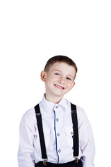 Smiling little boy holding wearing costume with braces.Happy little boy over white background.Smiling, Happy, Joyful beautiful little boy , looking at camera.