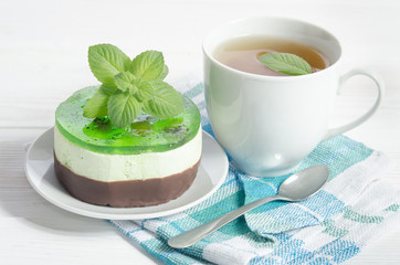 herbal tea with cake on white wooden table