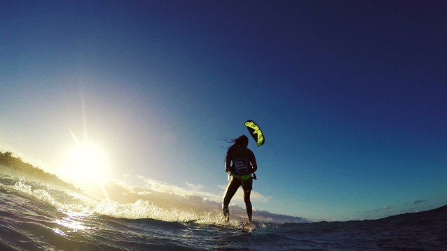 Extreme Kitesurfing at Sunset. Summer Ocean Sport in Slow Motion. Girl Kite Surfing in Bikini 