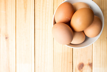 egg in bowl with wood background