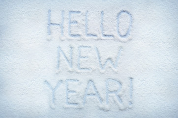 Text HELLO NEW YEAR written on snow. Horizontal postcard.