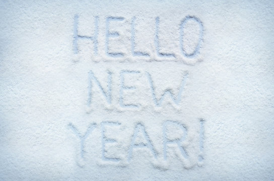 Text HELLO NEW YEAR written on snow. Horizontal postcard.