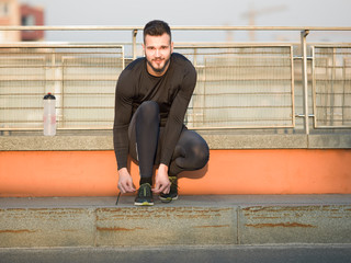 healthy lifestyle sports man tying shoelace before running, gold