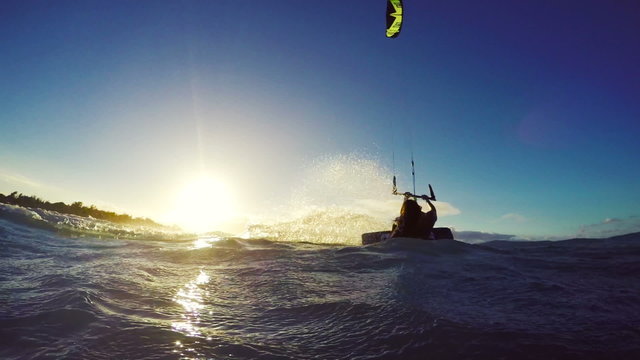 Extreme Kitesurfing at Sunset. Summer Ocean Sport in Slow Motion. Girl Kite Surfing in Bikini 