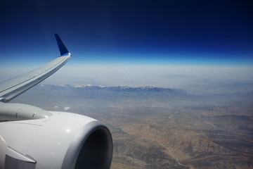 Looking through window aircraft, flying over Iraq.  View from airplane.