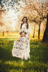 beautiful bride stands near the little girl