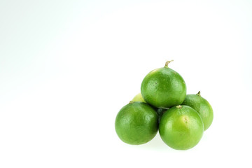 Green lemons isolated on white background
