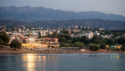 Panoramic night view of beach with hotel.