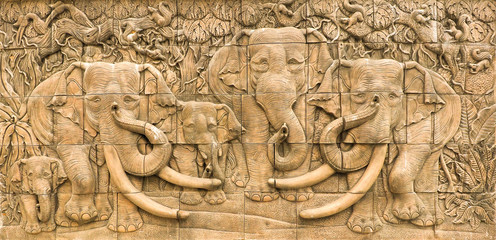 Fototapeta na wymiar The elephants stuccowork in the wall, Thailand style.