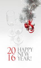 Greeting card template made of two champagne glasses with red and silver balls hanging on red ribbon and silver tinsel