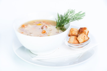 Soup with garlic croutons on a white background