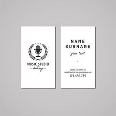 Music studio business card design concept. Music studio logo with vintage microphone and wreath. Vintage, hipster and retro style. Black and white.