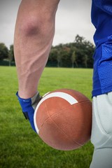 Composite image of midsection of sport person holding ball