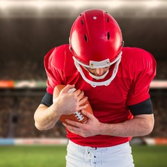 Composite image of american football player protecting football