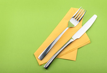 Fork and knife on green background
