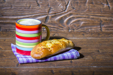 Beautiful colorful mug of fresh milk and homemade baget with che
