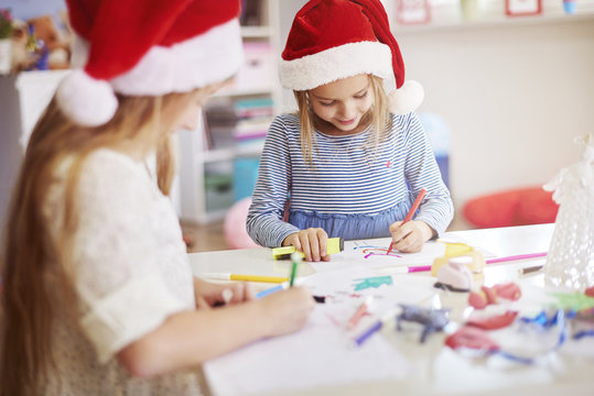 Children drawing some christmas paintings