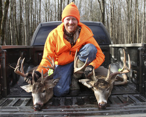 Happy Hunter With Two Trophy Bucks