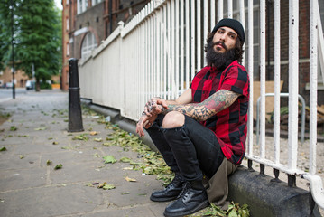 Young tattooed man intimate portrait in Shoreditch borough. London.