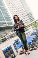 Young mixed race businesswoman portrait outdoors in Canary Wharf in London.