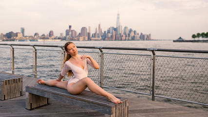Young beautiful ballerina dancing along New Jersey waterfront.