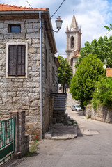 Fototapeta na wymiar Corsican village street view, old living houses