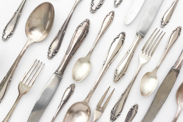 fancy silver cutlery set on white background - old sterling flatware set / pattern - obrazy, fototapety, plakaty