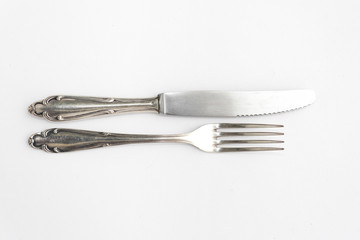 knife, fork - old fancy silver cutlery set on white background - beautiful sterling silver flatware