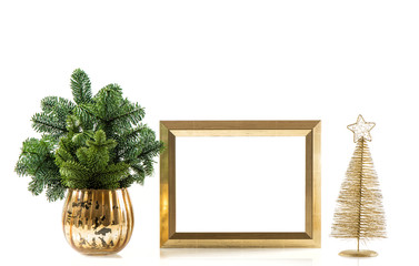 Golden picture frame and shiny christmas tree branches