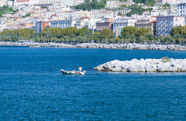 Obraz premium Fishing boat leaving the sea port of Salerno, Salerno, Italy.