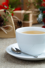 Christmas table with green tea and christmas balls.