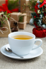 Christmas table with green tea and christmas balls.