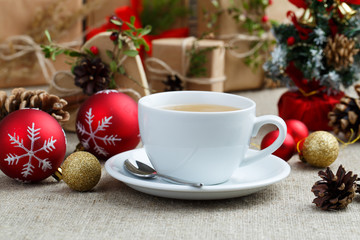 Christmas table with green tea and christmas balls.