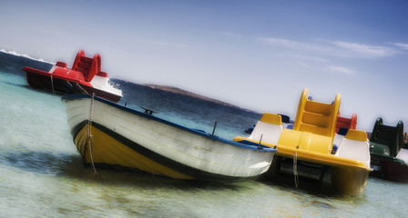 Pleasure rowing boats and pedalos tied up in sardinia caprera