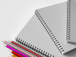 notebook with colored pencils on White background