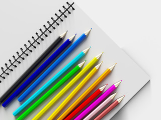 Obraz premium notebook with colored pencils on White background