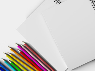 Fototapeta premium notebook with colored pencils on White background