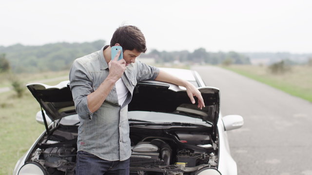  Stranded man with broken down car calls for help