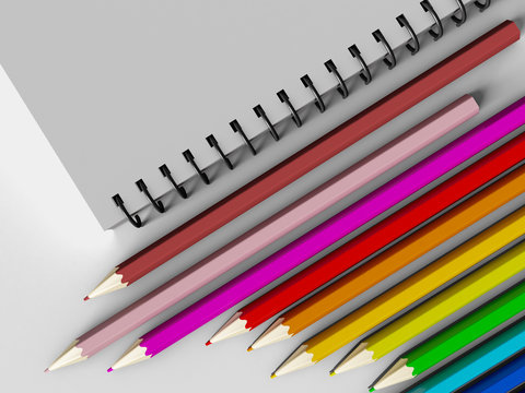 notebook with colored pencils on White background