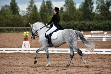Female dressage rider exercising