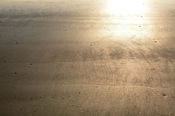 Background beach evening sun shines a light on the ground.