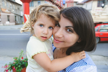 Obraz premium Girl Hugging Smiling Mother