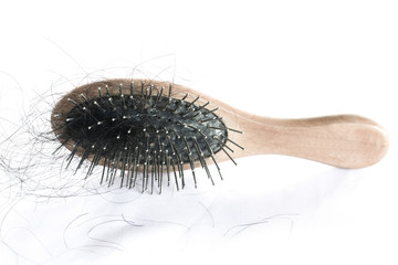 comb brush with lost hair on white cloth