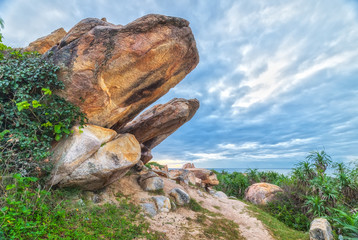 Stone tiger head with cloud dawn early ocean and head toward the sky tiger create natural beauty in the waters of Binh Thuan, Vietnam