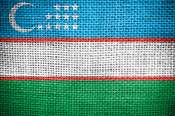 Uzbekistan flag on fabric surface