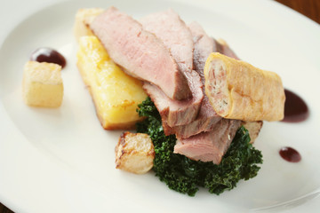 plated duck breast meal with vegetables