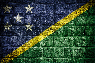 Solomon Islands flag on old brick wall